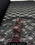 Black floral stretch lace fabric 4-way stretch label, 90% nylon 10% spandex