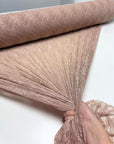 Nude Floral Stretch Lace Fabric blush colored roll showing texture and drape