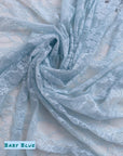 Baby blue floral stretch lace fabric draped with baby blue label