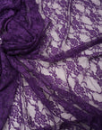 Deep eggplant purple floral stretch lace fabric close-up showing delicate floral pattern