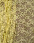 Close up of pale yellow floral lace fabric showing texture and transparency