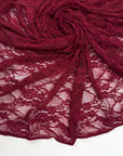 Burgundy Floral Stretch Lace Fabric draped and swirled showing deep red texture