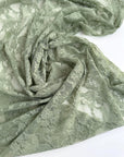 Sage Green Floral Stretch Lace Fabric draped showing semi-sheer matte finish