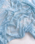 Baby Blue Floral Stretch Lace Fabric draped in airy light blue folds