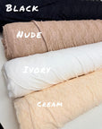 Floral stretch lace fabric rolls showing color range including eggplant purple
