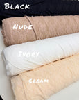 Nude floral stretch lace fabric roll close-up showing color options