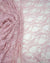 Blush pink floral stretch lace fabric draped and folded showing intricate pattern