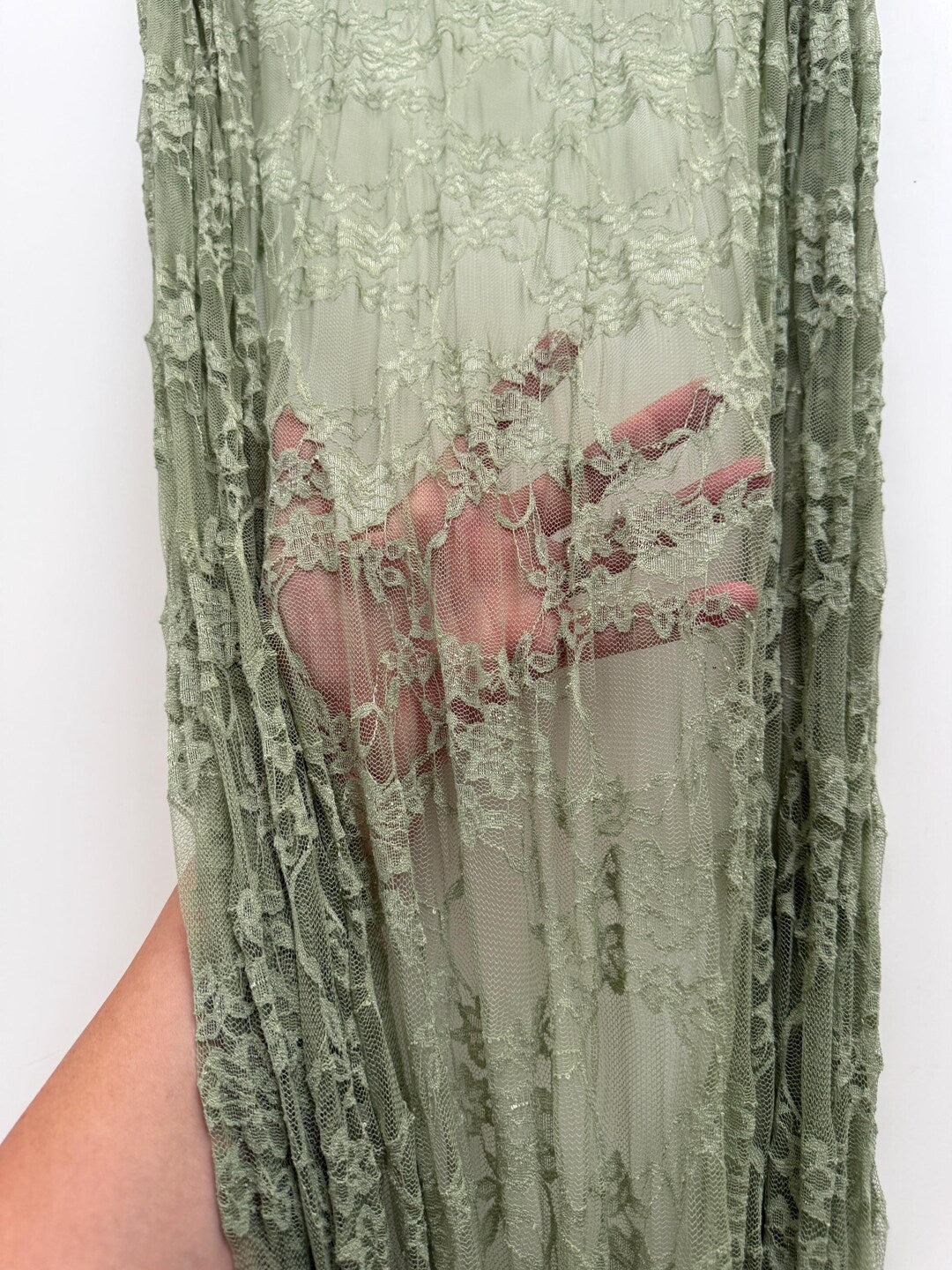 Sage Green Floral Stretch Lace Fabric draped showing delicate vintage floral pattern