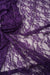 Deep eggplant purple floral stretch lace fabric close-up showing delicate floral pattern