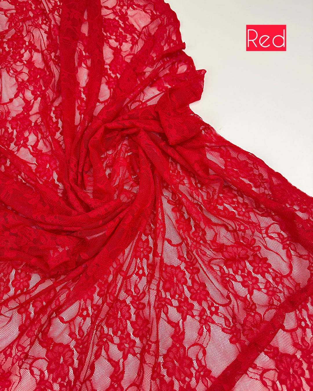 Bright red floral stretch lace fabric draped with red color label, 4-way stretch