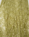 Close-up detail of moss green floral stretch lace fabric showing intricate pattern
