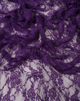Deep purple eggplant floral lace fabric draped showing rich color and sheer texture