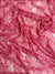 Coral vintage floral stretch lace fabric close-up draped showing vibrant color