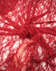 Red Floral Stretch Lace Fabric close up deep red bunched and draped semi-transparent