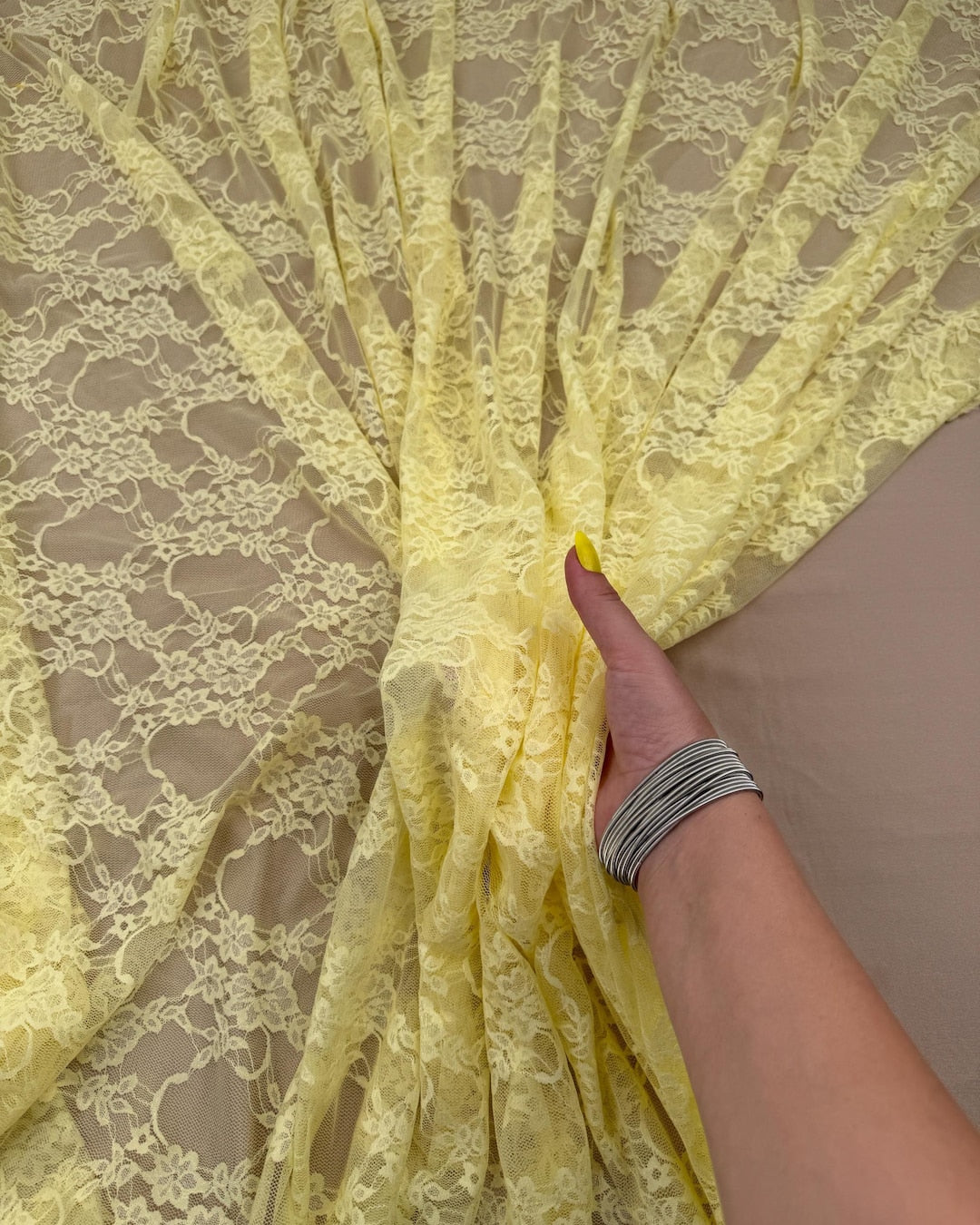 Butter Yellow Floral Stretch Lace Fabric draped showing delicate floral pattern