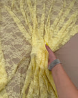 Butter Yellow Floral Stretch Lace Fabric draped showing delicate floral pattern