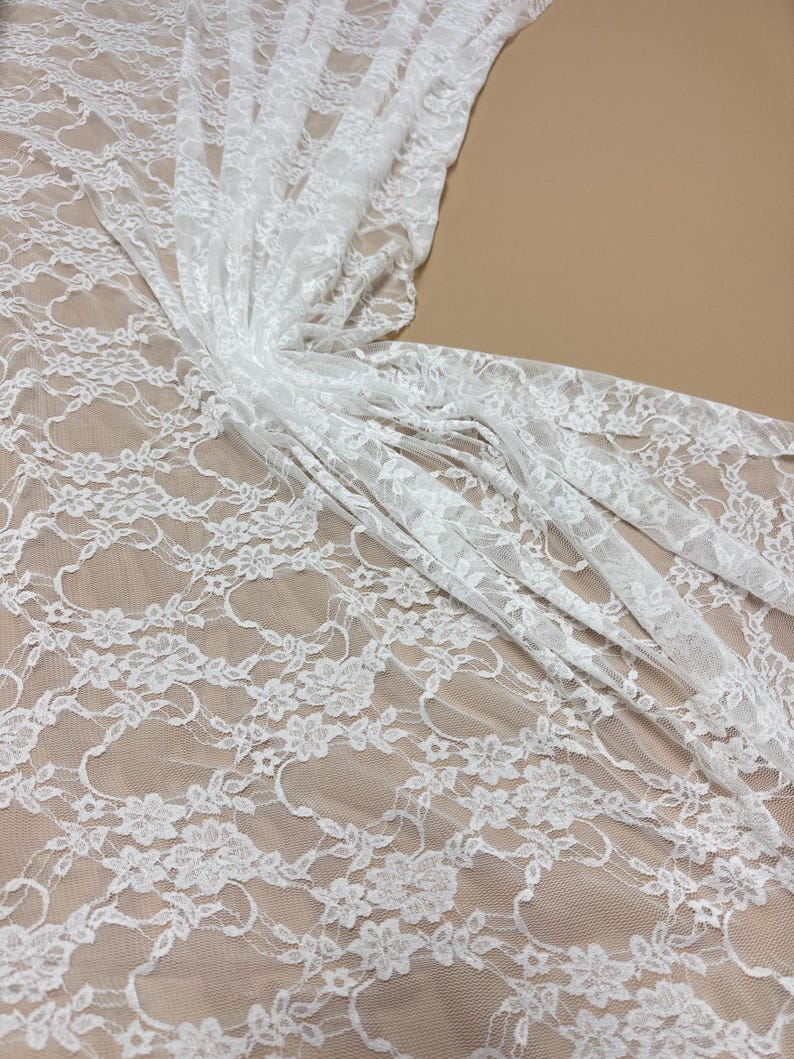 Ivory Floral Stretch Lace Fabric bright draped showing intricate design