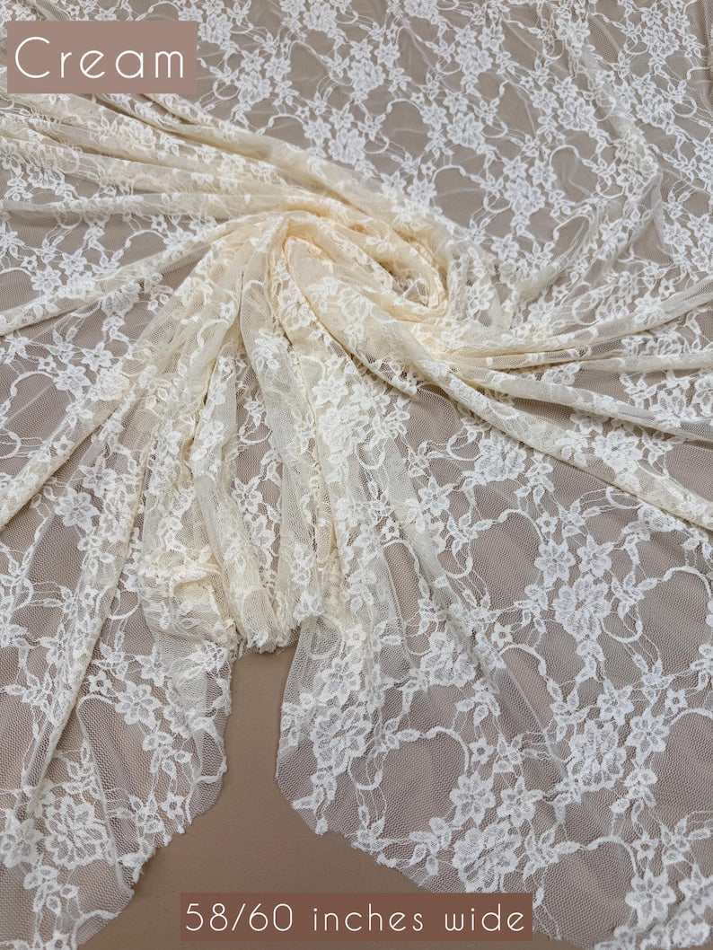 Cream Floral Stretch Lace Fabric draped with Cream label 58/60 inches wide