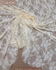Cream Floral Stretch Lace Fabric draped with Cream label 58/60 inches wide