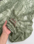 Sage Green Floral Stretch Lace Fabric sheer draped with intricate floral details
