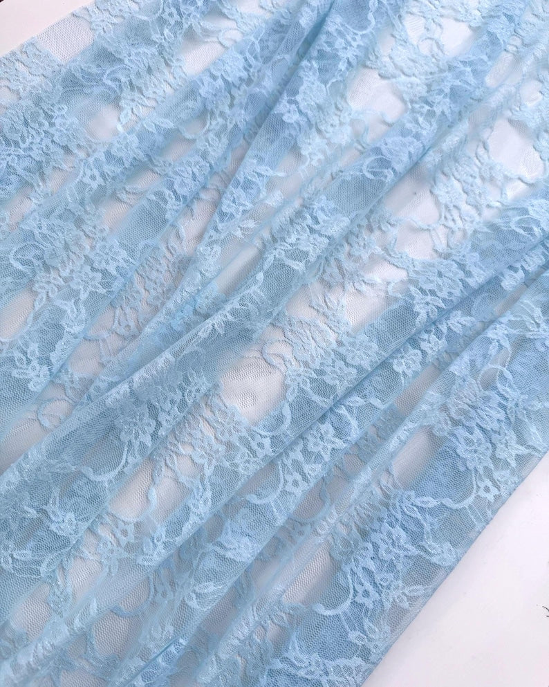 Baby Blue Floral Stretch Lace semi-transparent fabric draped in soft folds