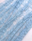 Baby Blue Floral Stretch Lace semi-transparent fabric draped in soft folds