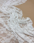 Ivory Floral Stretch Lace Fabric draped and layered showing intricate floral design