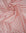 Dusty pink satin fabric with small white polka dots draped in soft folds
