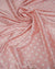 Dusty pink satin fabric with small white polka dots draped in soft folds