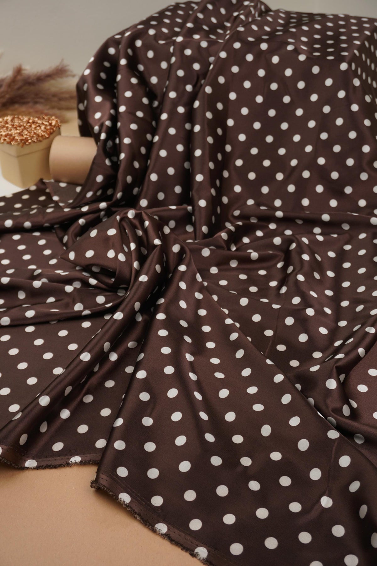 Brown polka dot satin fabric drape
