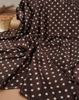 Brown polka dot satin fabric drape