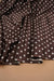 Chocolate brown and ivory polka dot stretch satin fabric draped in soft folds