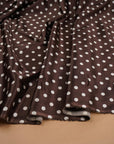 Chocolate brown and ivory polka dot stretch satin fabric draped in soft folds