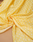 Length of yellow polka dot satin fabric