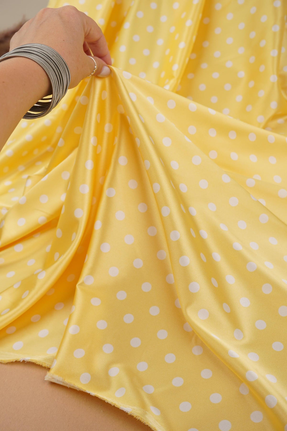 Yellow and white polka dot satin folds