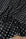 Black and white polka dot stretch satin fabric draped in soft folds