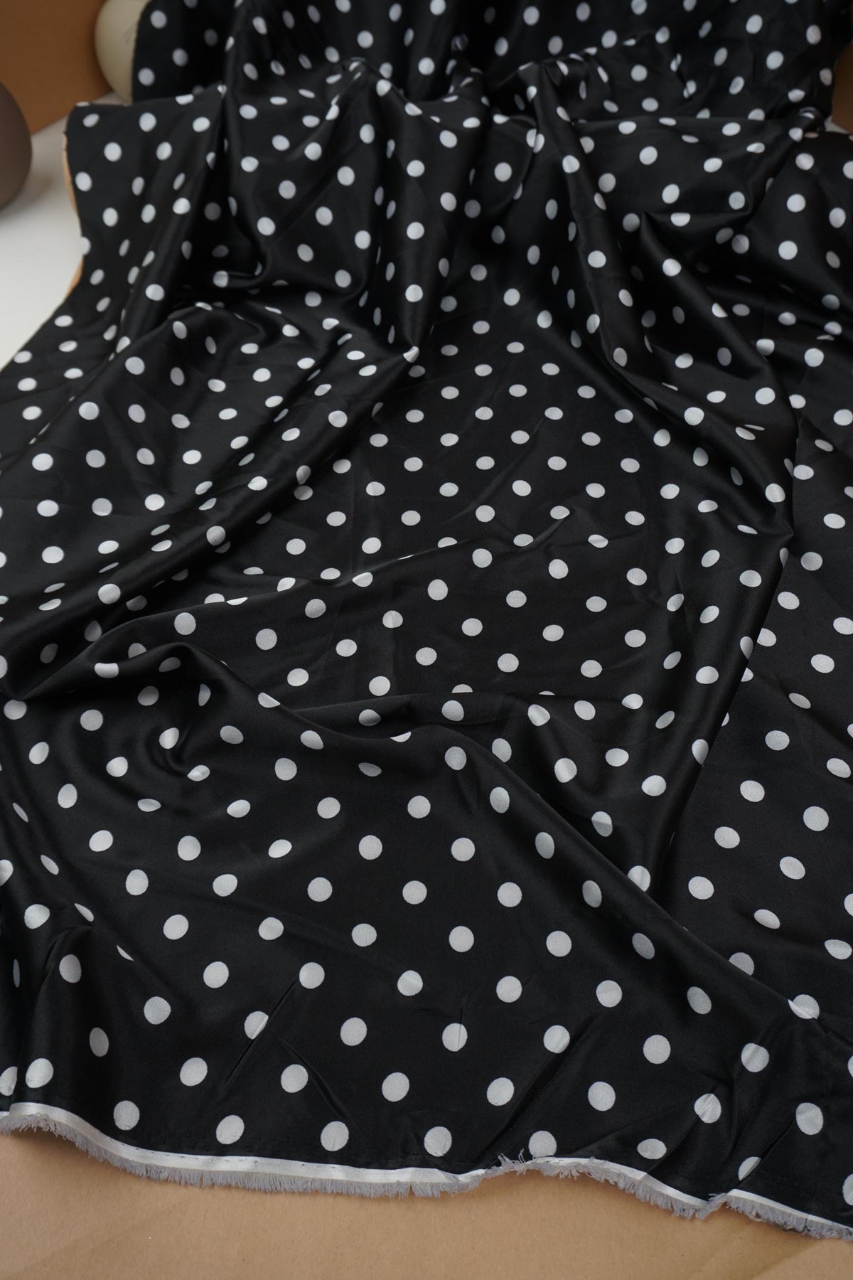 Black and white polka dot satin fabric drape